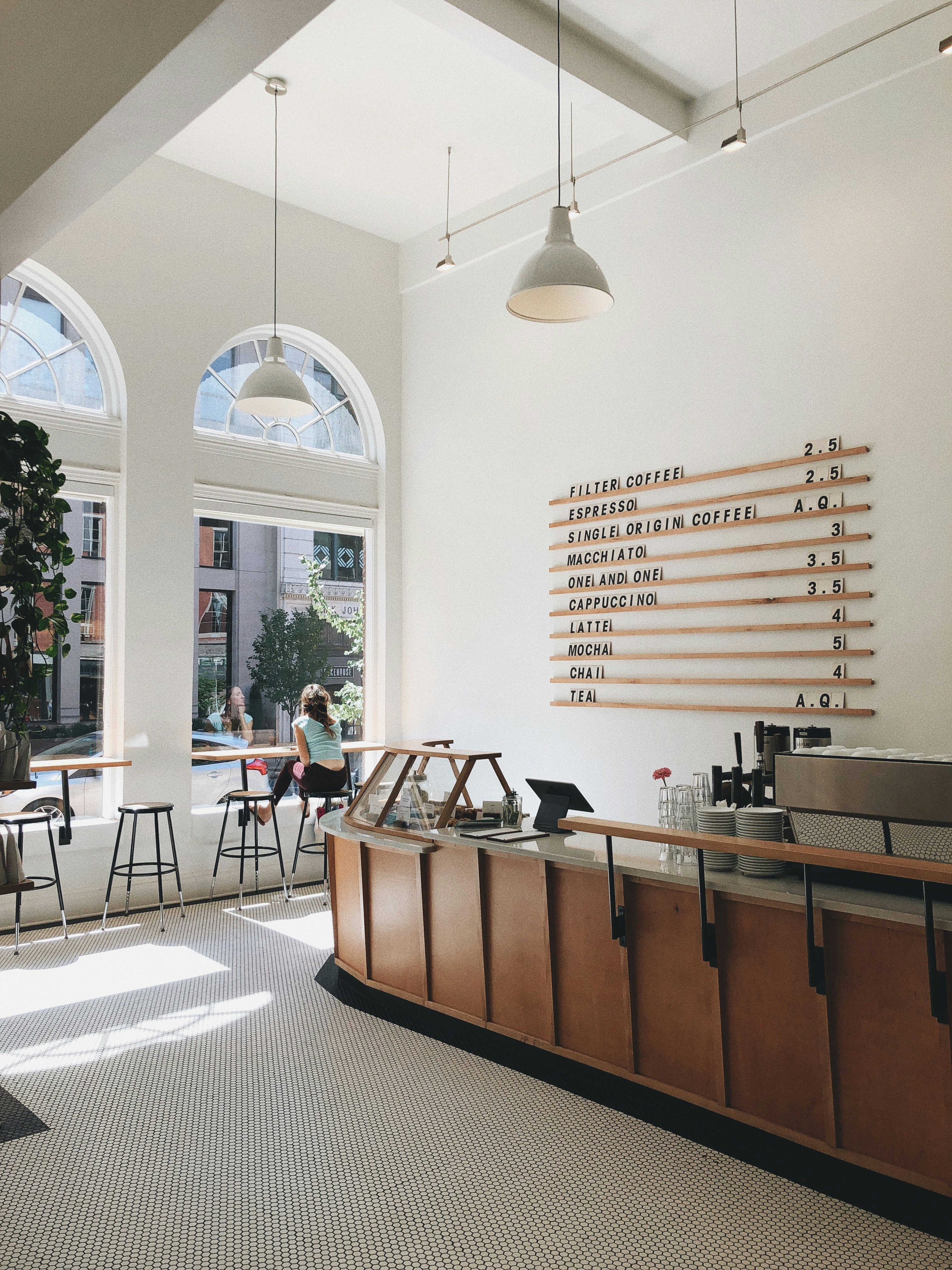 Cafe interior with arched windows and a wooden counter